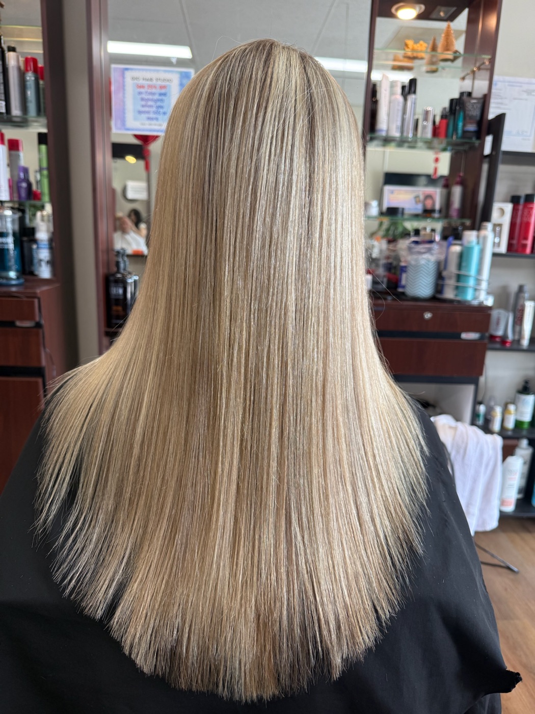 Sleek full-length blonde highlights, back view, no face visible